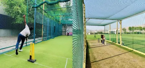 Batters and bowlers practising inside cricket practice nets
