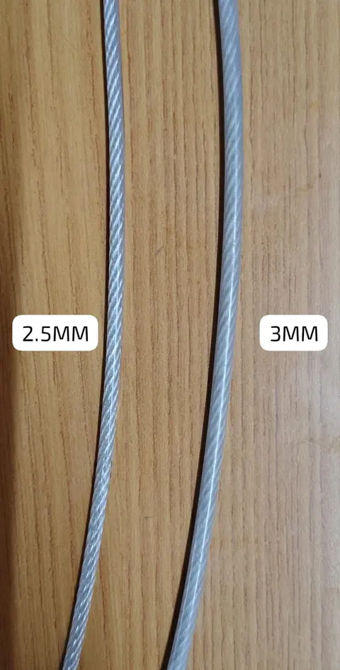 Two lengths of nylon-coated invisible grill wire, 2.5 mm and 3 mm, laid side by side for comparison